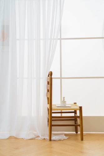 Biała, przezroczysta firanka woalowa 300x250 cm w minimalistycznym wnętrzu.